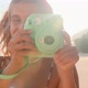 Young Caucasian Woman Cute Smiling Takes Picture on Funny Camera Stands on Beach - VideoHive Item for Sale