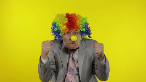 Elderly Clown Businessman Entrepreneur Boss Making Silly Faces. Copy Space alt