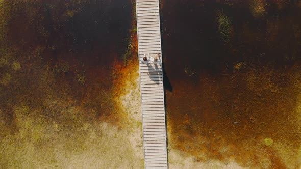 People are walking on a wooden bridge Summer Baikal lake Olkhon island alt