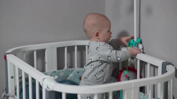 Baby Standing in a Crib at Home