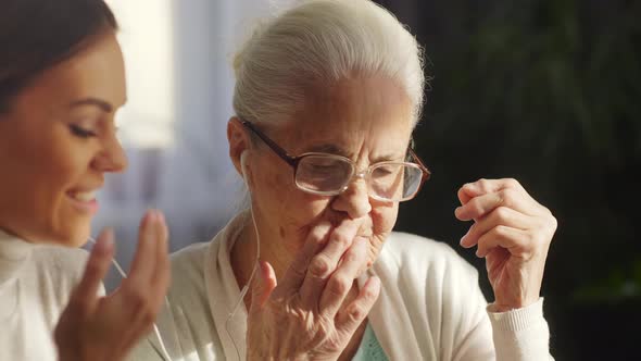 Senior Grandmother and Young Woman Video Calling on Tablet