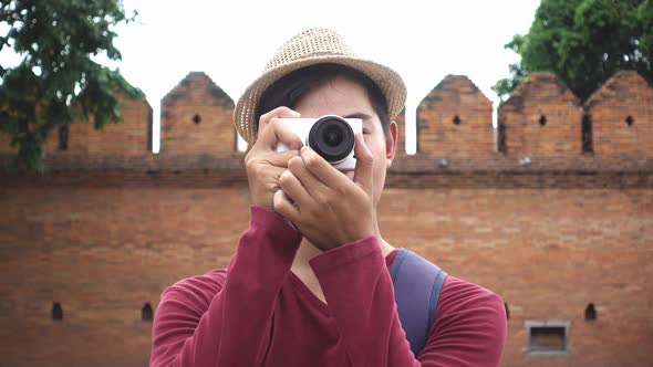 Young traveler take a photo with digital camera.