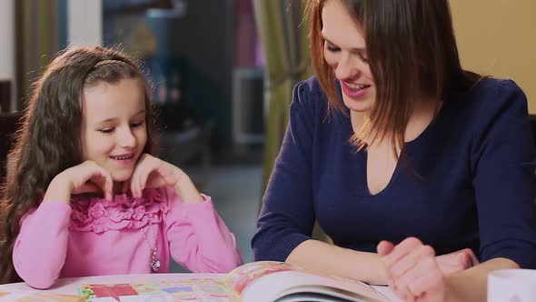 Close-Up Mother Teaching Little Daughter, Reading Color Book alt