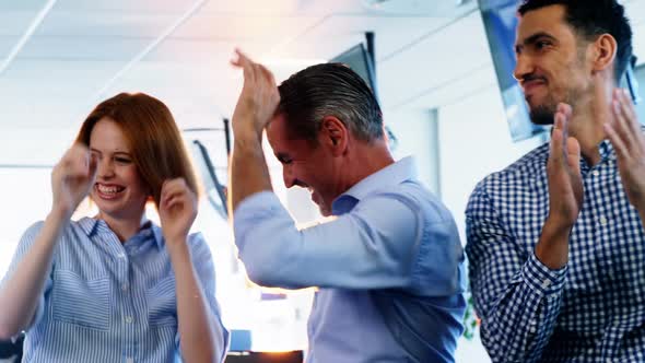 Team of business executives celebrating their success alt