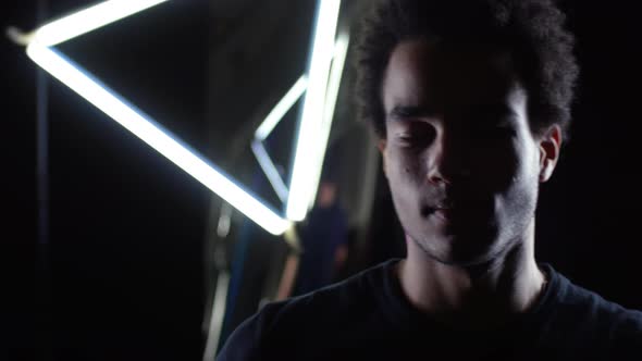 Mixed-race Man Dancing in Darkness alt