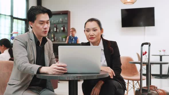 Businesswoman using laptop talking about the project and consults with project manager in the office