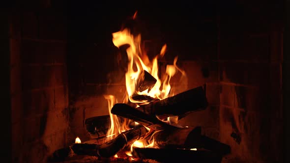 A Glowing Fire in the Stone Fireplace Warm Cozy Fireplace with Real Wood Burning in it alt