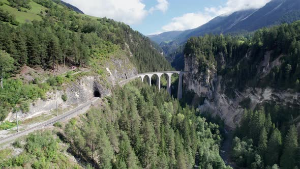 Landwasser Viaduct in Swiss Alps in Summer Aerial View on Green Mountain Valley alt