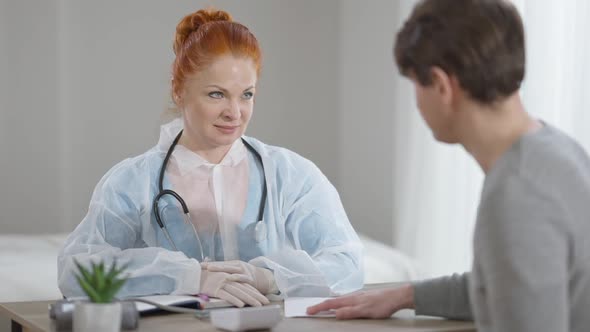 Confident Female Doctor Receiving Bribe From Male Patient alt