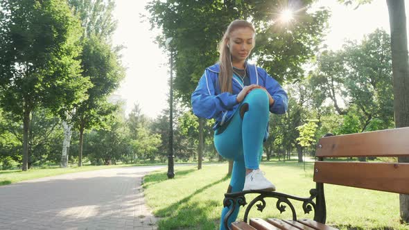 Attractive Sportswoman Stretching Outdoors in the Park