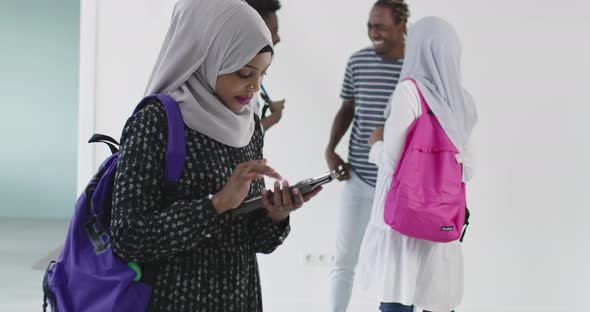 Musilm Student with Group of Friends in Background Wearing Traditional Islamic Hijab Clothes and