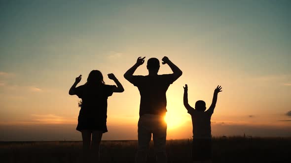Happy family: father, children son and daughter on nature on sunset