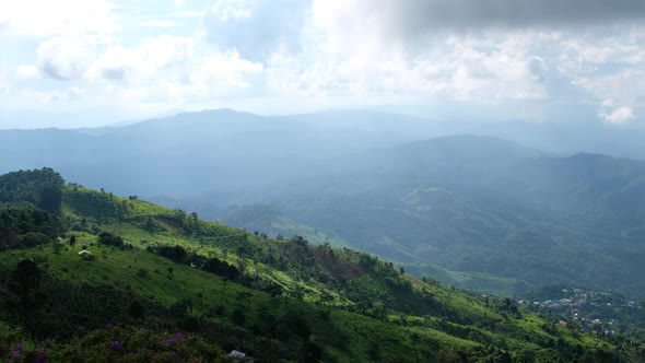 Aerial view of the sky and mountains on cloudy day by drone