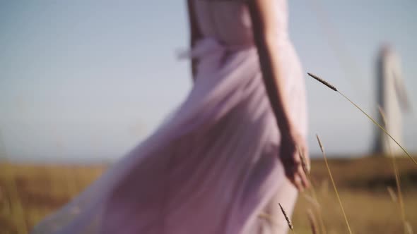 the dress develops in the wind at the lighthouse alt