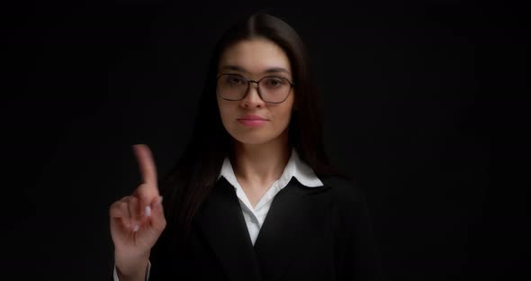 Portrait of Serious Young Businesswoman Raising Forefinger Up Saying No