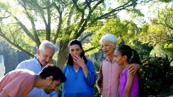 Family standing together in park 4k alt