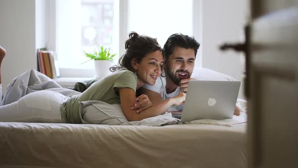 Happy Married Caucasian Couple Using Laptop at Home Spbd alt