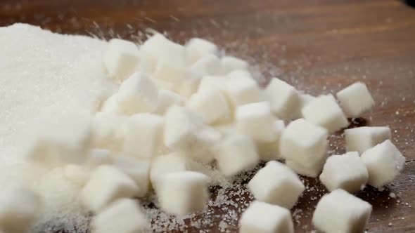 White Sugar Lumps Scattered Onto Sand Sugar On Brown Wooden Table