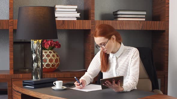 Stylish Redhead Girl Working at Home Office