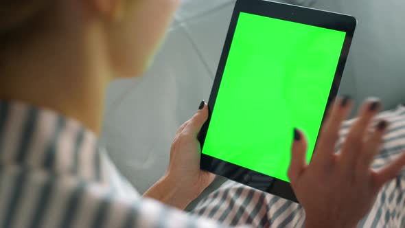 Woman Talking Online Green Tablet Screen Closeup alt