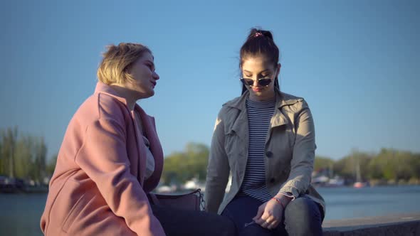 Girls Walking on Quay Talking Friends Smiling Woman Friendship Concept