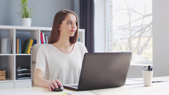 Young Woman Works at Home Office Using Computer. alt