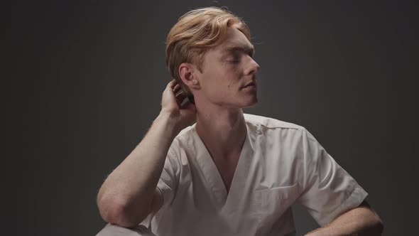 Portrait Of Young Guy In Medical Gown alt