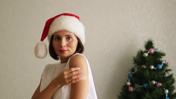 Portrait of a female in Christmas hat smiling after getting a vaccine