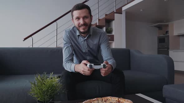 Man Using Joystick and Playing in Video Games at Home