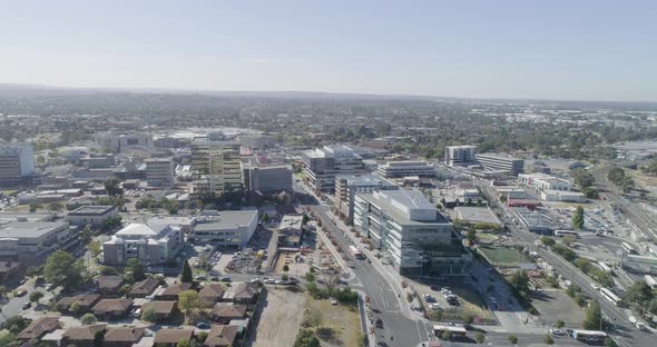 Dandenong City from aerial perspective with many public buses moving through the main streets below. alt