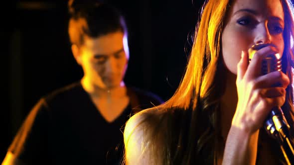 Band performing in studio alt