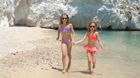 Little Girls Having Fun at Tropical Beach During Summer Vacation alt