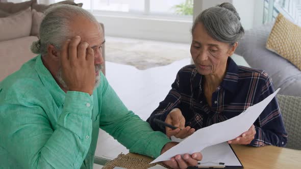 Mature couple talking at home alt