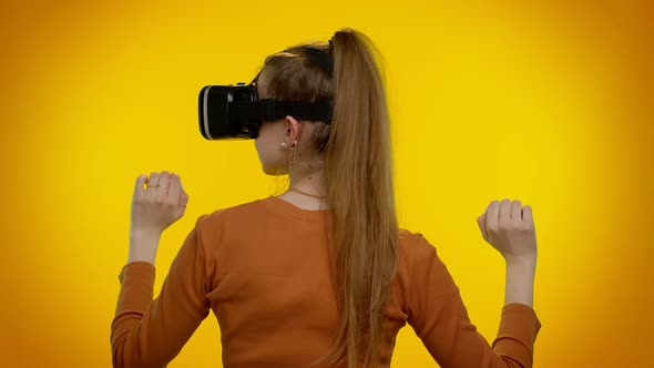 Girl Using Virtual Reality Futuristic Technology VR Headset Helmet to Play Simulation 3D Video Game alt