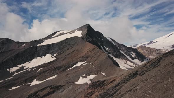 Aerial Shot with a Rocky Mountain Peaks Rarely Covered with Snow