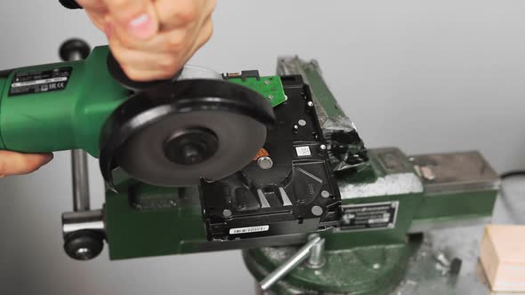 Worker Cuts Open Hard Disk Drive with Circular Saw in Studio alt