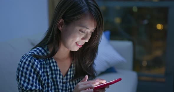 Woman use of mobile phone at night alt