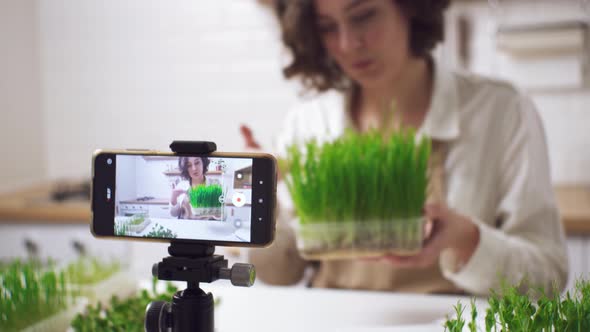 Healthy Food Blogger Girl Talking While Recording Video Green Sprouts, Vlog Concept, Women alt