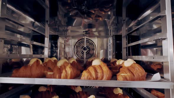 Freshly Baked French Golden Croissants on Baking Trays in Bakery alt