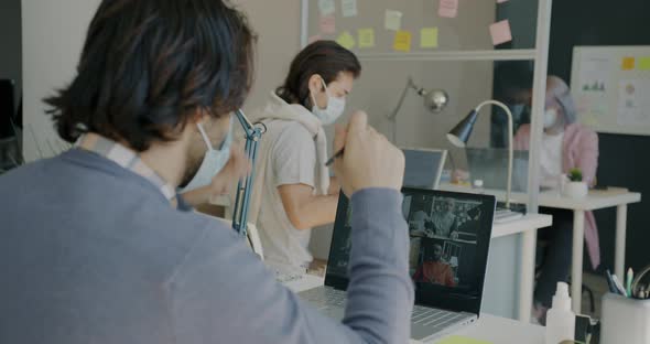 Portrait of Businessman Wearing Face Mask Making Online Video Call From Office alt