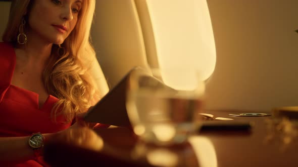 Airplane Passenger Holding Tablet Computer Closeup alt