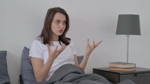 Woman Feeling Worried While Sitting in Bed alt