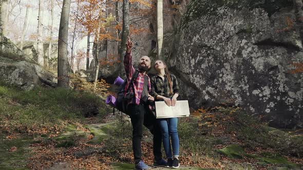 Man and a Woman Enjoying Views of the Mountain Rush. Young Man and Woman Stand in the Mountains alt