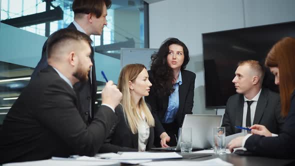 Group of Executive Managers Discussing Project at Meeting alt