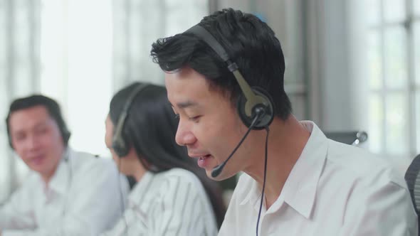 A Man Call Centre Agents Speaking To Customers While His Colleagues Are Talking With Each Other alt