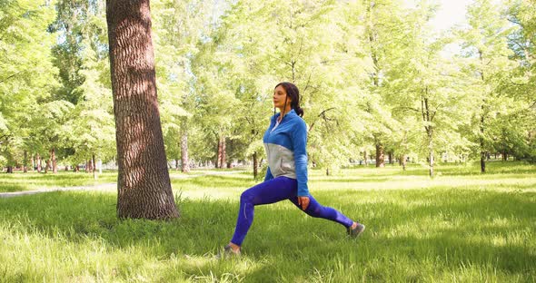 A 30Yearsold Woman Practices Yoga in a City Park alt