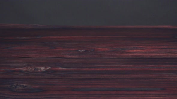 Large wedge of semi soft part-skim swiss cheese on a dark wooden background. alt