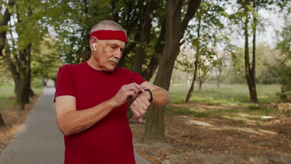 Senior Old Man Running in Park and Using Smart Watch, Tracking Result After Fitness Workout alt