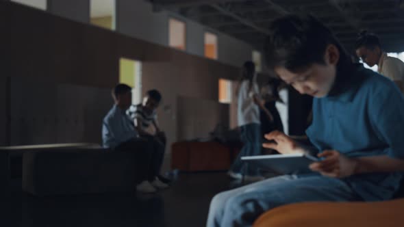 Preteen Schoolboy Playing Online Game on School Break alt