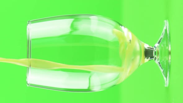 Vertical Video Juice Pouring Into Goblet Isolated on Light Green Background